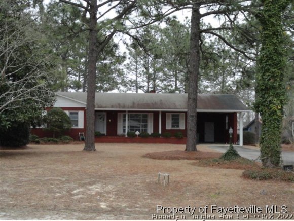 4667 Legion Road Hope Mills, NC 28348 - Photo 1 of 24 a front view of a house with a garden