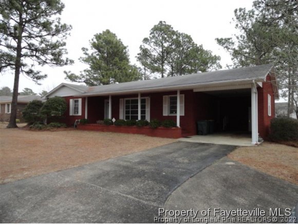 4667 Legion Road Hope Mills, NC 28348 - Photo 23 of 24 a front view of a house with a yard and garage