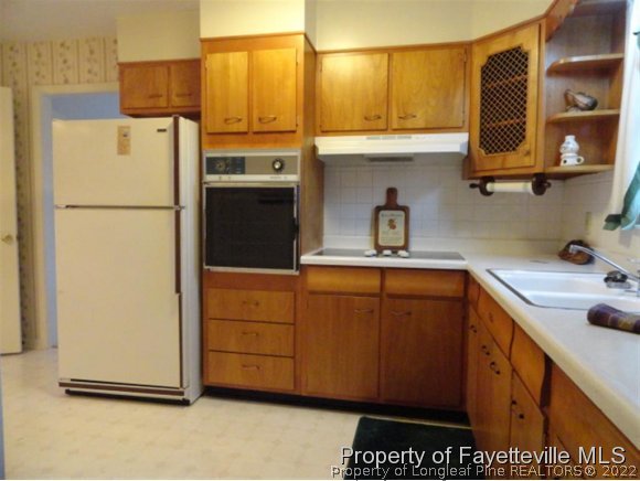 4667 Legion Road Hope Mills, NC 28348 - Photo 5 of 24 a kitchen with stainless steel appliances a refrigerator and a sink