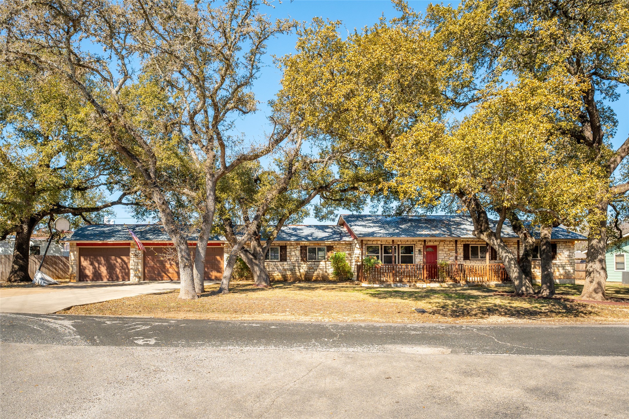 18 Presidio Road Wimberley, TX 78676 - Photo 1 of 1 Grandfather Oaks cast shade over the front yard of 18 Presidio.