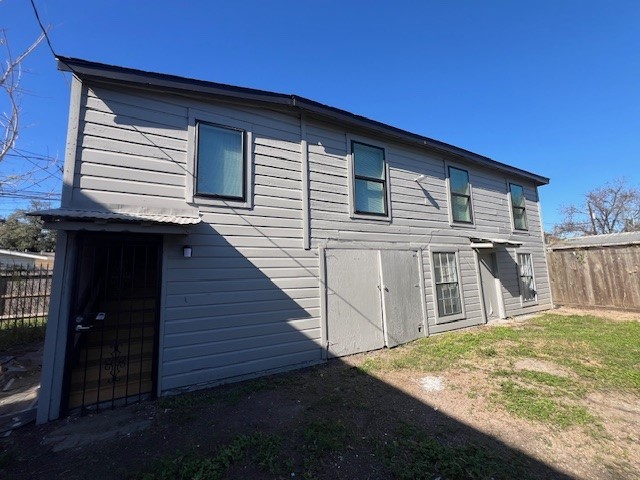 a view of a house with wooden fence