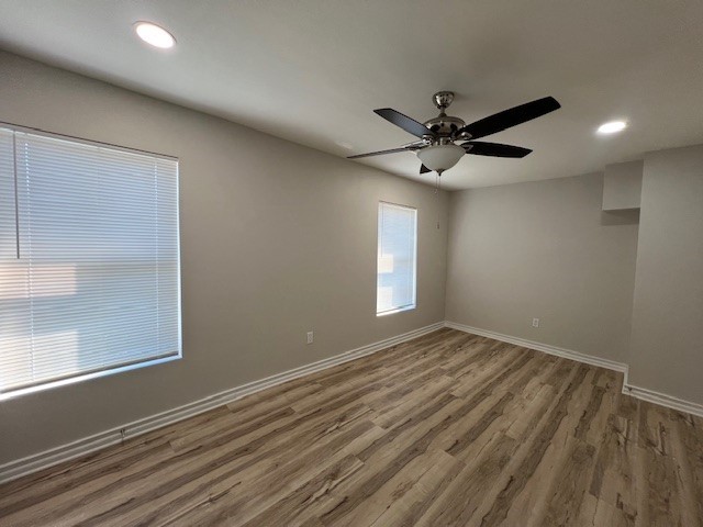407 1/2 Walton Street Houston, TX 77009 - Photo 7 of 14 an empty room with windows and fan