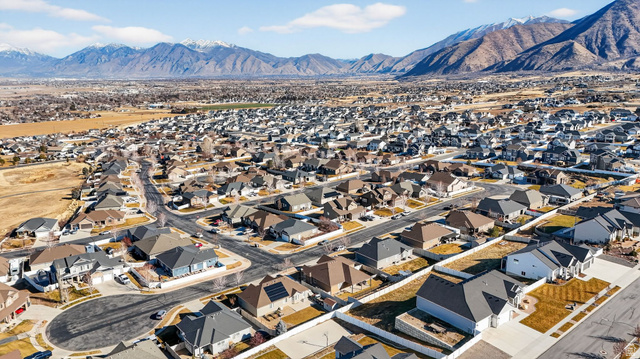 141 Wolverine Creek Elk Ridge, UT 84651 - Photo 45 of 47 Aerial perspective of suburban area featuring a mountainous background