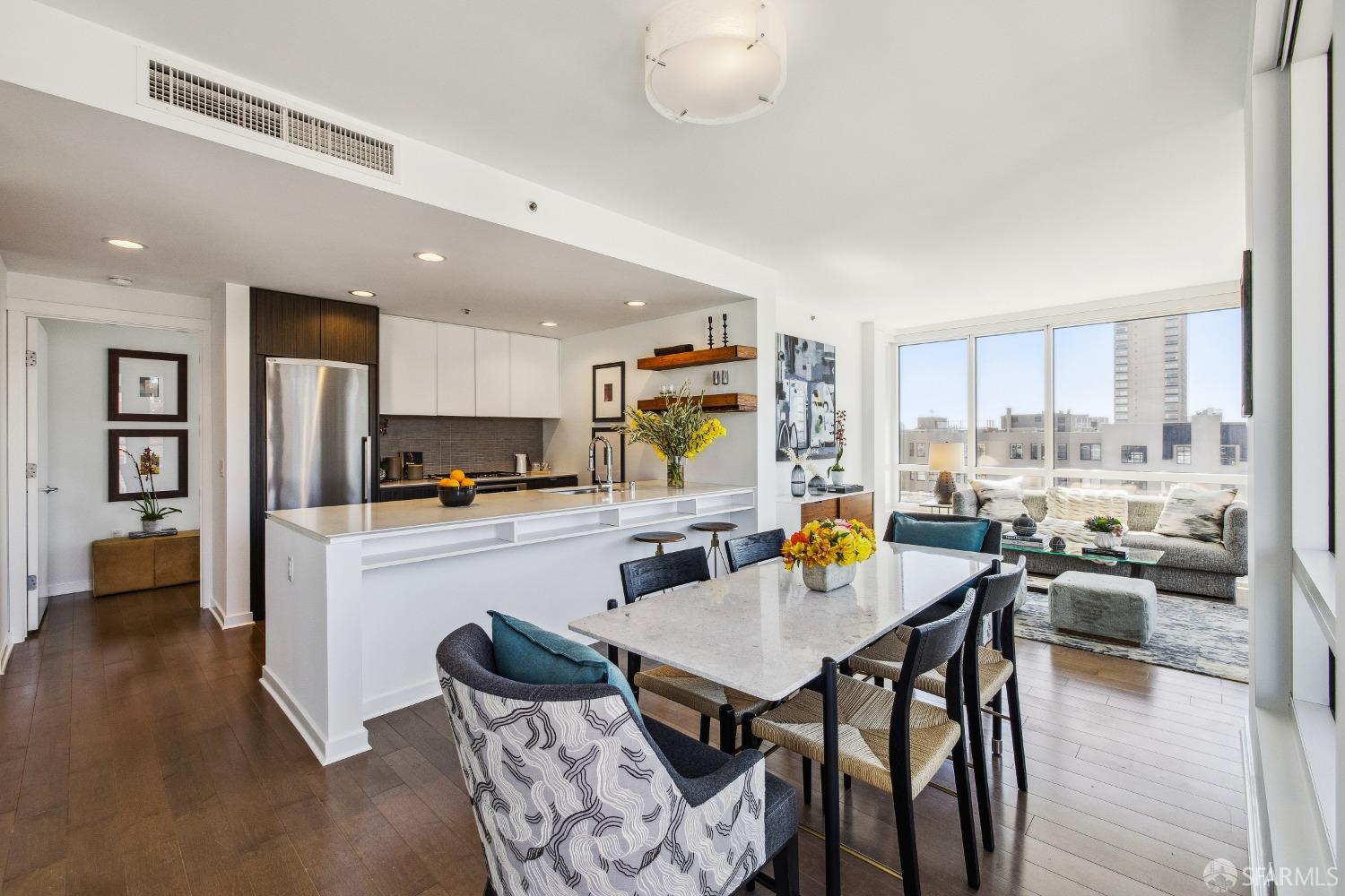 1788 Clay Street, Unit 807 San Francisco, CA 94109 - Photo 11 of 28 a kitchen with stainless steel appliances kitchen island granite countertop a dining table and chairs