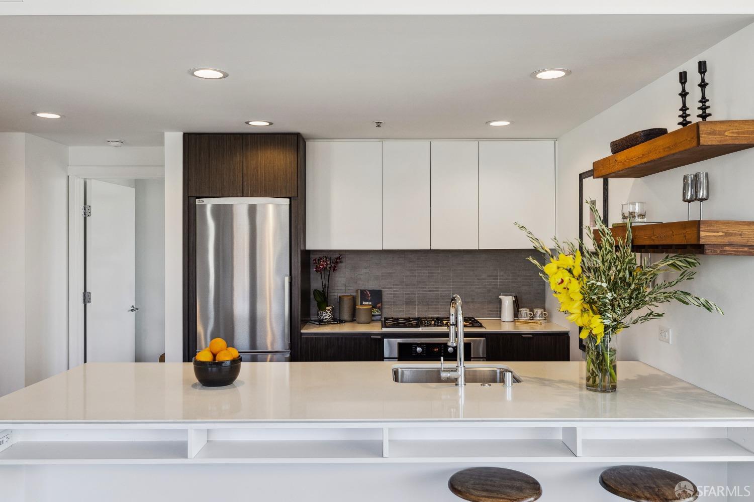 1788 Clay Street, Unit 807 San Francisco, CA 94109 - Photo 13 of 28 a kitchen with stainless steel appliances granite countertop a refrigerator and a sink