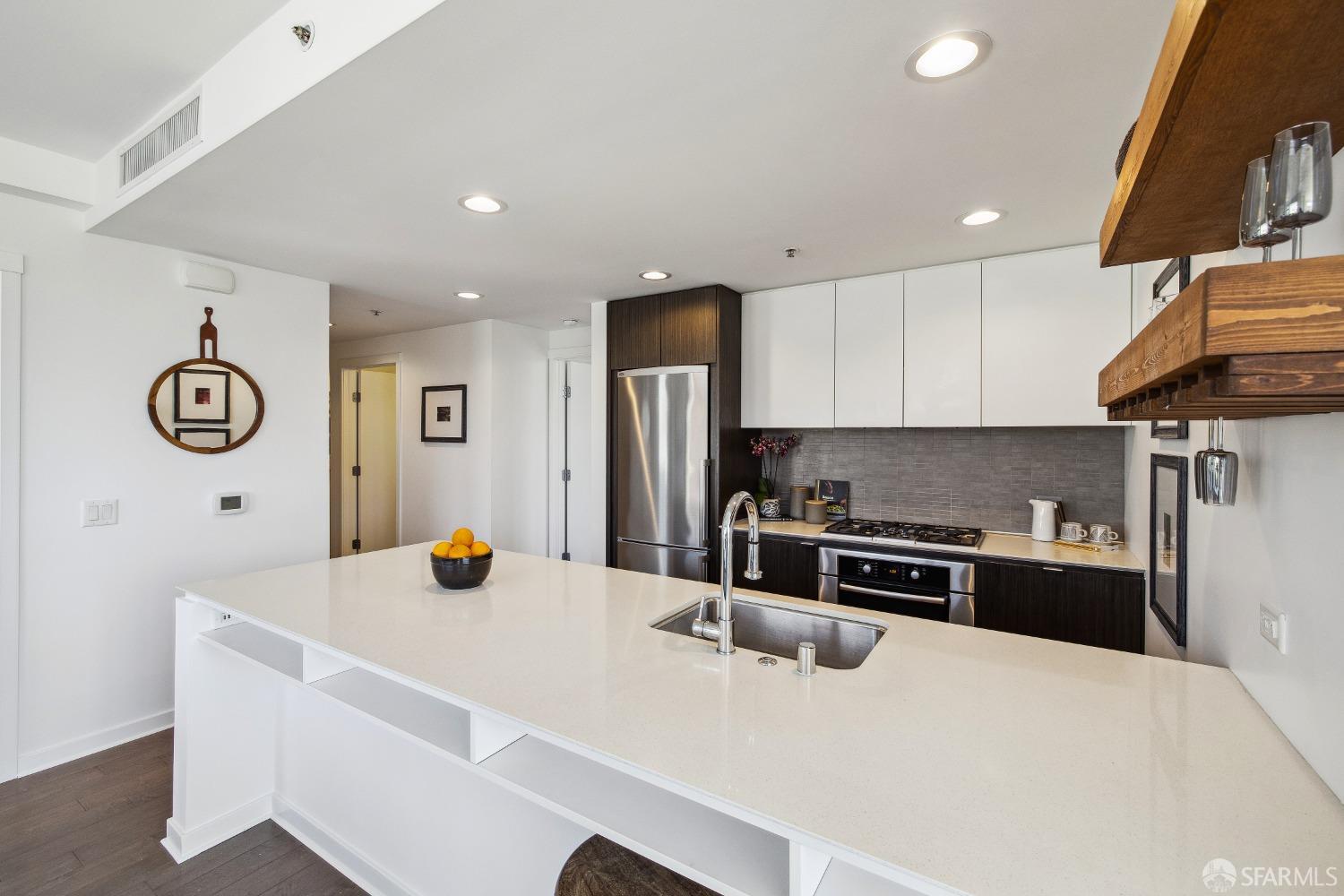1788 Clay Street, Unit 807 San Francisco, CA 94109 - Photo 14 of 28 a kitchen with stainless steel appliances granite countertop a sink a stove a refrigerator a microwave a counter top and cabinets