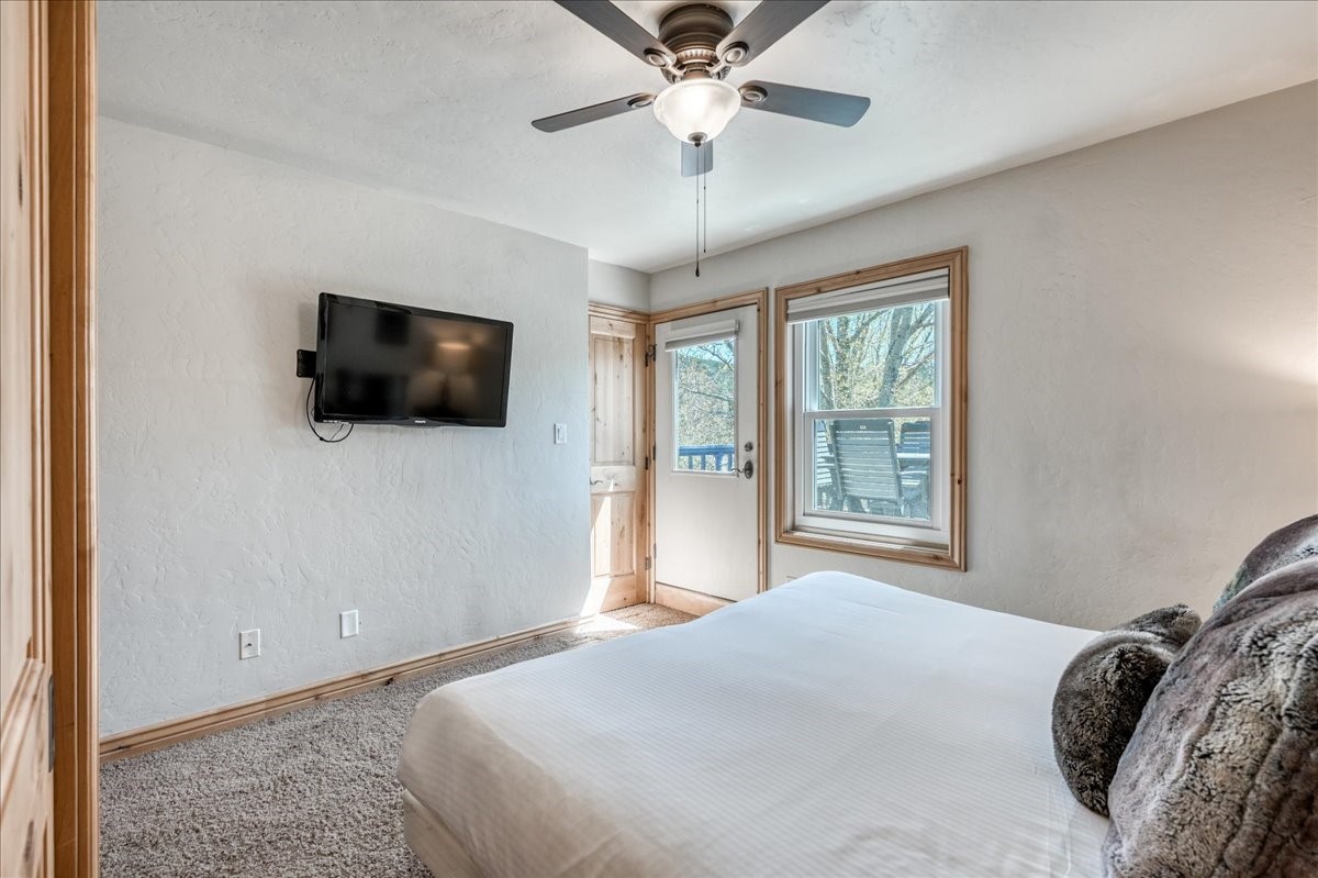 200 North Ridge Street, Unit R A Breckenridge, CO 80424 - Photo 23 of 38 a bedroom with a large bed a flat screen tv and a window