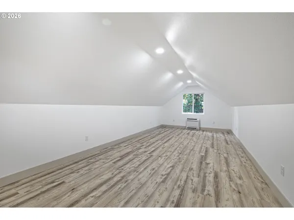 a view of an empty room and wooden floor