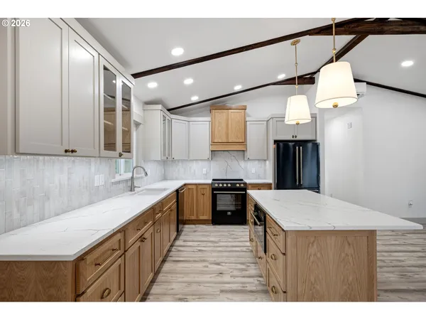 a kitchen with a stove a sink and a refrigerator