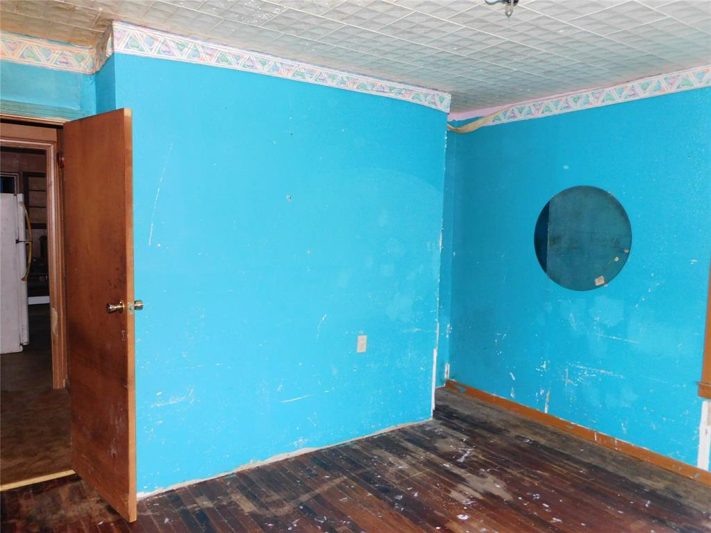 104 North Pecan Avenue Hubbard, TX 76648 - Photo 16 of 21 a view of a room with a wooden wall