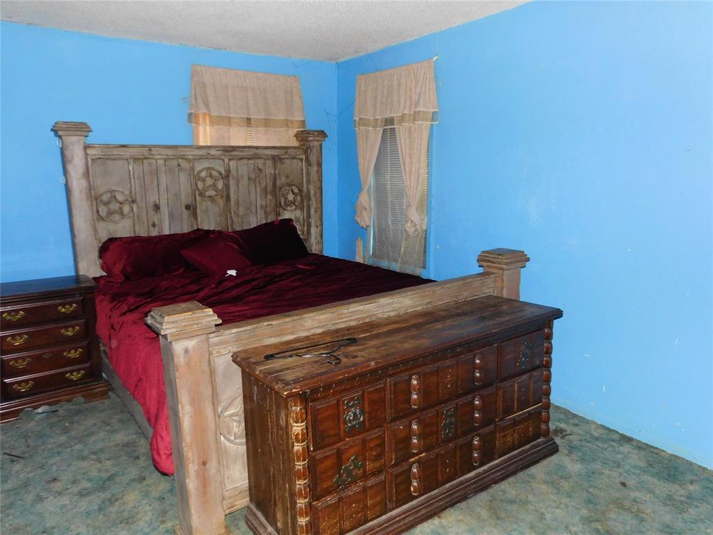 104 North Pecan Avenue Hubbard, TX 76648 - Photo 20 of 21 a bed sitting in a bedroom next to a cabinet