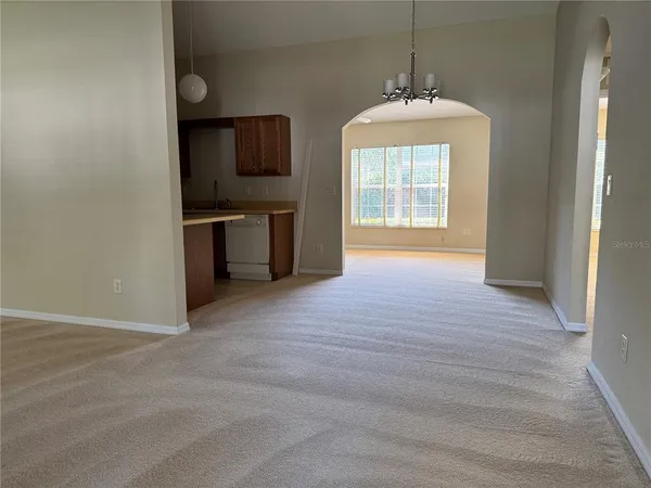 a view of a room with an empty space and a window