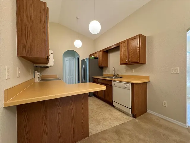 a kitchen with sink a microwave and stove