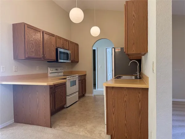 a kitchen with stainless steel appliances a stove microwave and sink