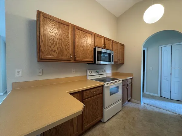 a kitchen with a stove microwave and sink