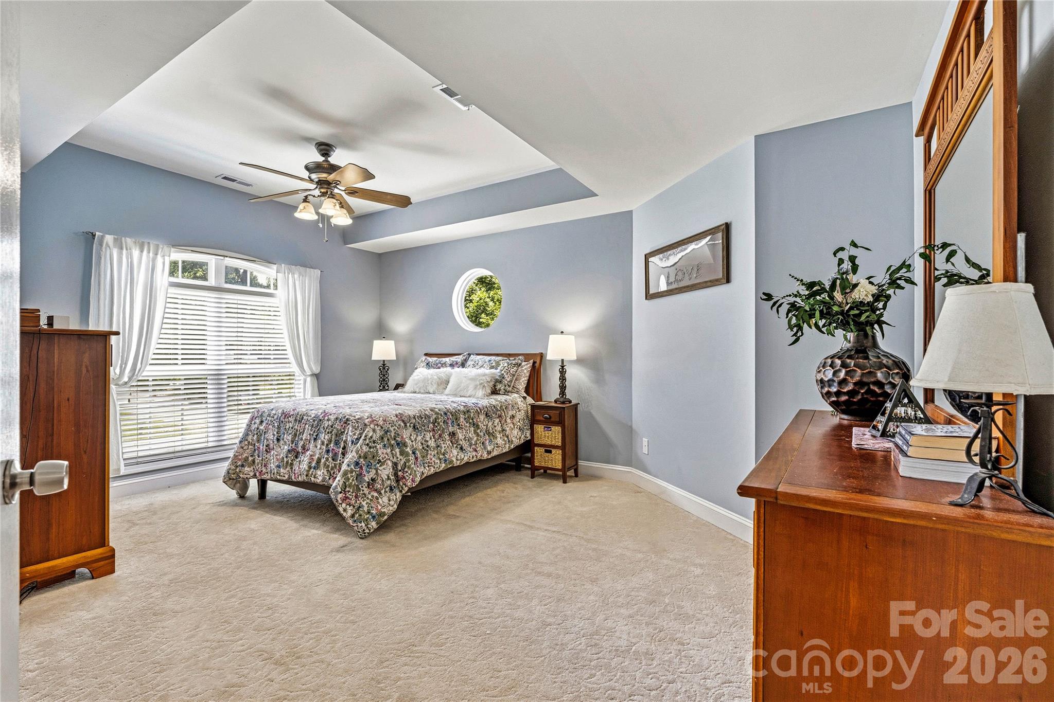 1606 High Ridge Drive Stanley, NC 28164 - Photo 19 of 44 a bedroom with a bed potted plant on dresser and a chandelier