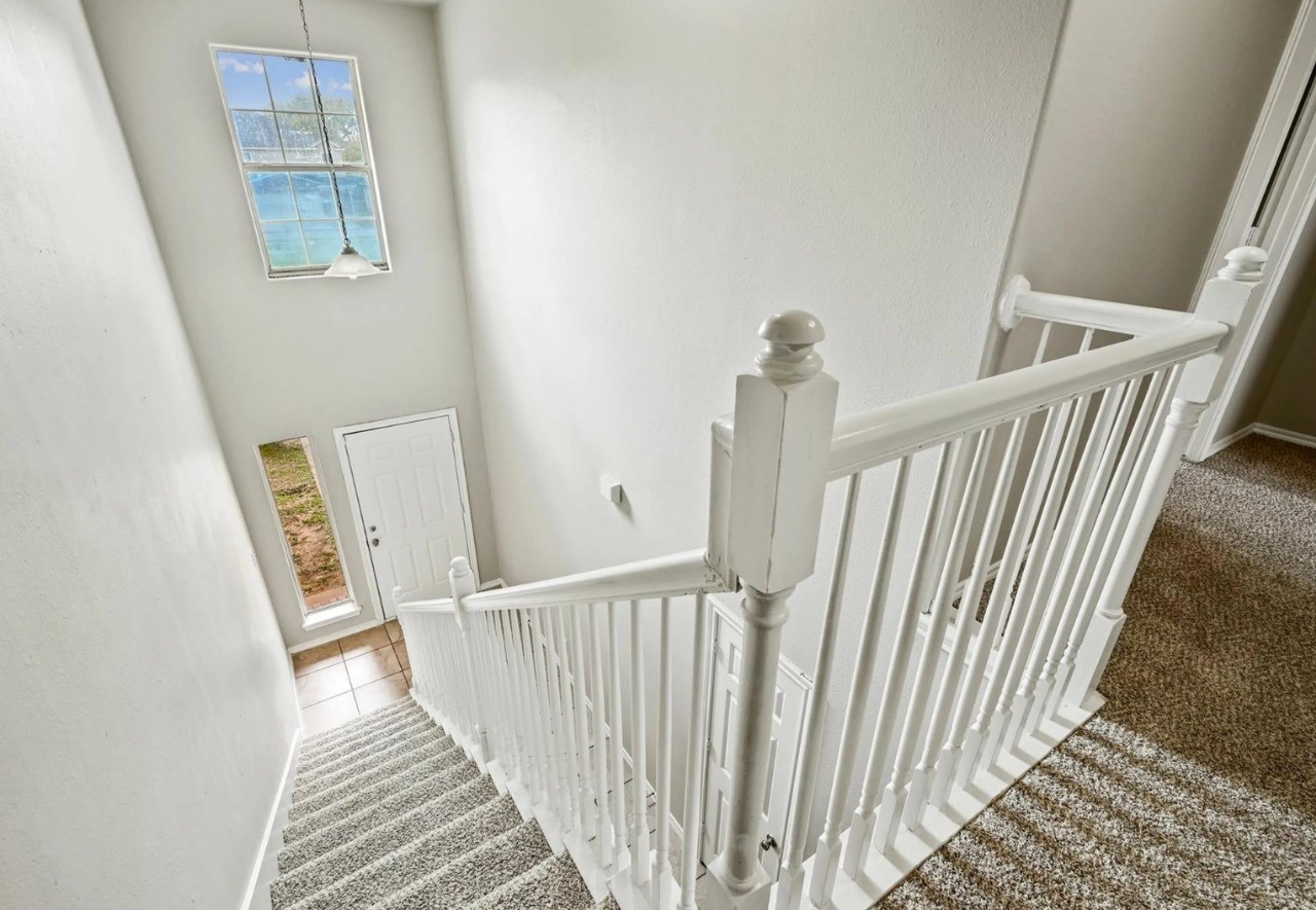 12010 Sarah Lake Drive Houston, TX 77099 - Photo 16 of 20 a view of a hallway with wooden floor and windows