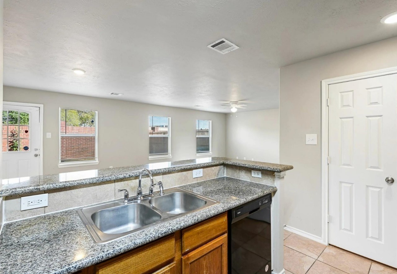 12010 Sarah Lake Drive Houston, TX 77099 - Photo 3 of 20 a kitchen with granite countertop a sink and a window
