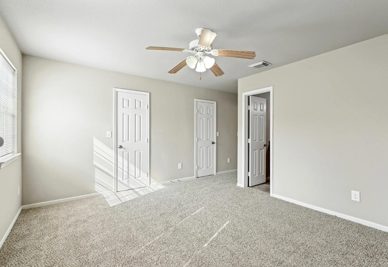 12010 Sarah Lake Drive Houston, TX 77099 - Photo 8 of 20 an empty room with windows and fan