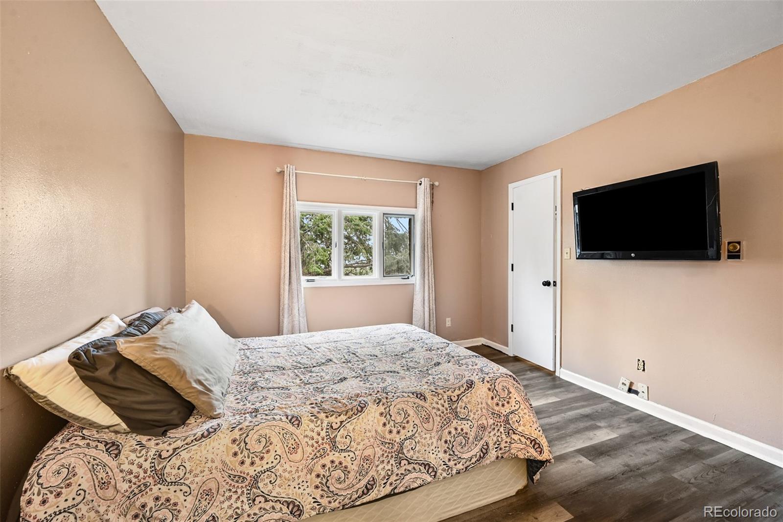 312 South Pine Drive Bailey, CO 80421 - Photo 16 of 32 a bedroom with a bed and a flat screen tv