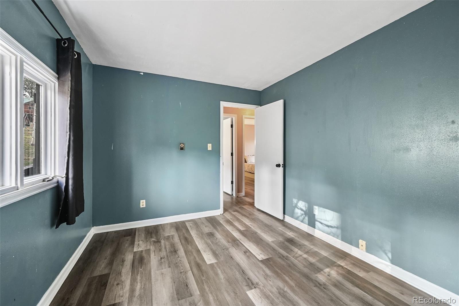 312 South Pine Drive Bailey, CO 80421 - Photo 19 of 32 a view of a room with wooden floor and a bathroom