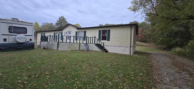a view of a house with a yard and a garden