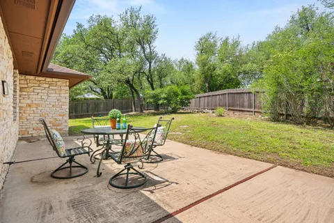 a view of a backyard with sitting area