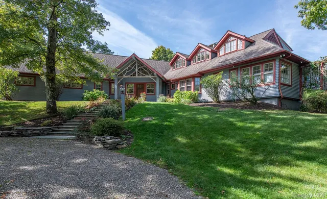 a view of a house with a yard and potted plants