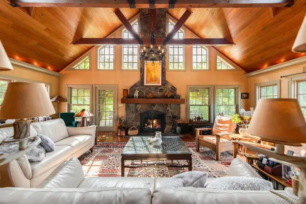 a living room with furniture a fireplace and a flat screen tv