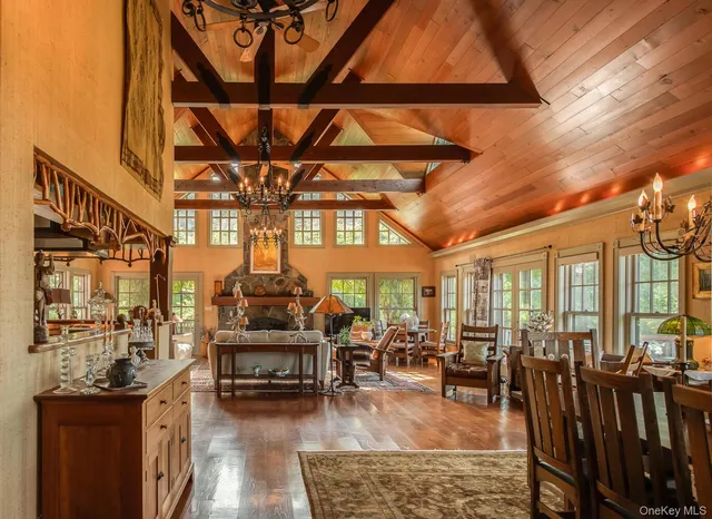 a living room with furniture a chandelier and large windows