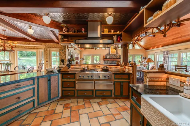 a view of a kitchen with stainless steel appliances granite countertop a stove and a sink