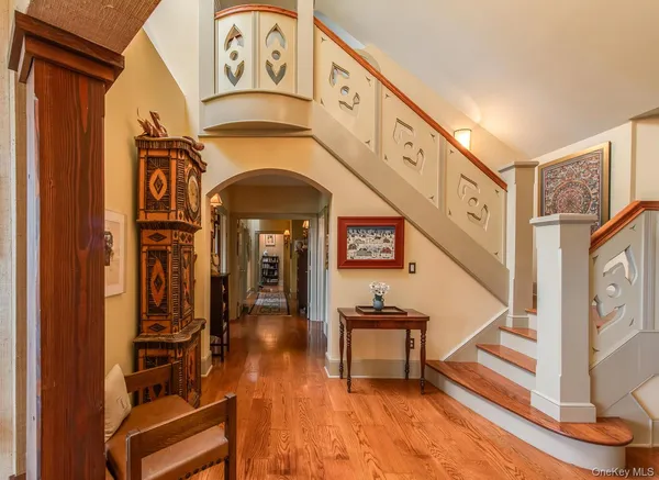 a view of entryway livingroom and hall with wooden floor