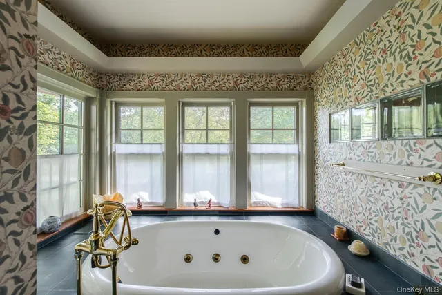 a bath tub sitting next to a window