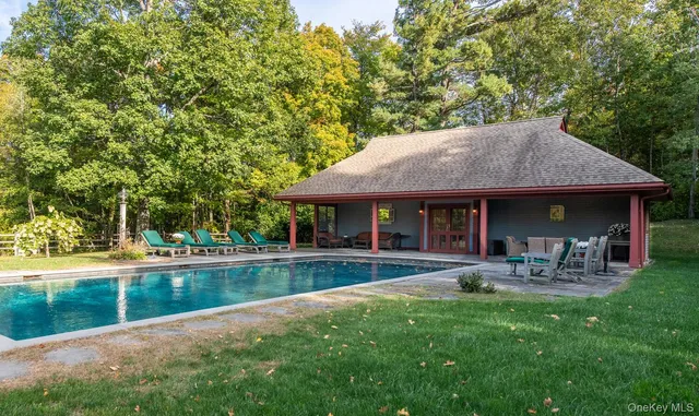 a view of a house with a yard and sitting area