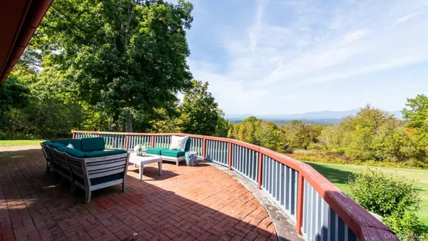 a balcony with wooden floor and outdoor space
