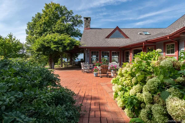 a view of a house with sitting area and garden