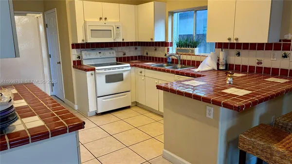 a kitchen with a stove and a microwave
