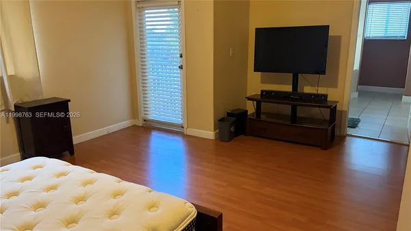 a living room with hard wood floors and a wooden floor
