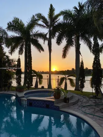 a view of a lake with palm trees