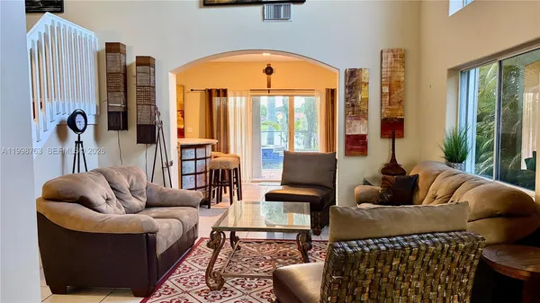 a living room with furniture and a large window
