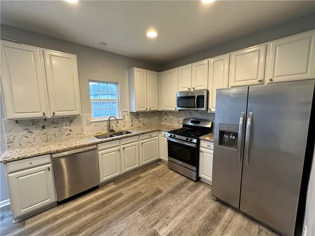 a view of kitchen with furniture and wooden floor
