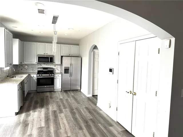 a kitchen with a sink stove and refrigerator