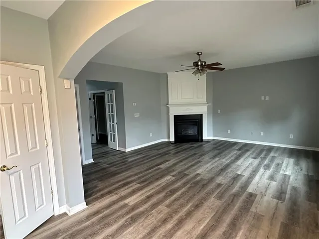 wooden floor in an empty room with a fireplace