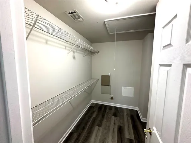 a view of a house with a big yard next to a large building