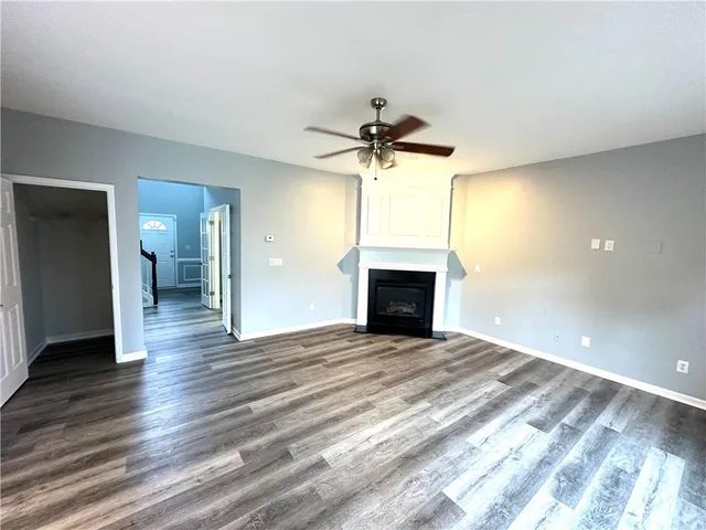 wooden floor in an empty room with a fireplace