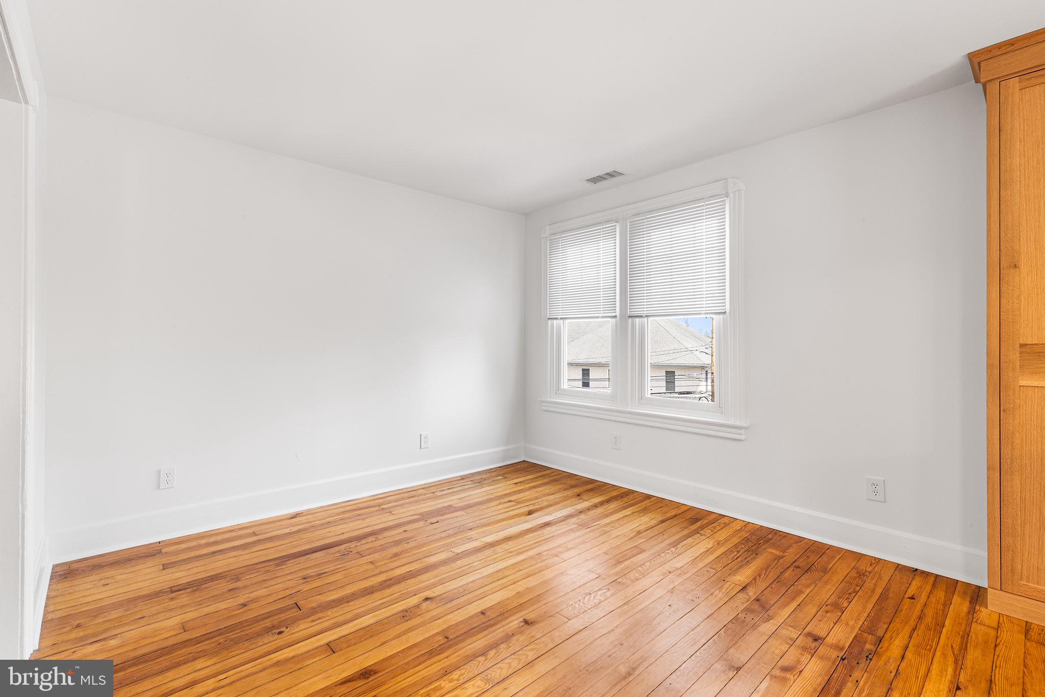 250 Conestoga Road, Unit 2 Wayne, PA 19087 - Photo 12 of 24 an empty room with wooden floor and windows