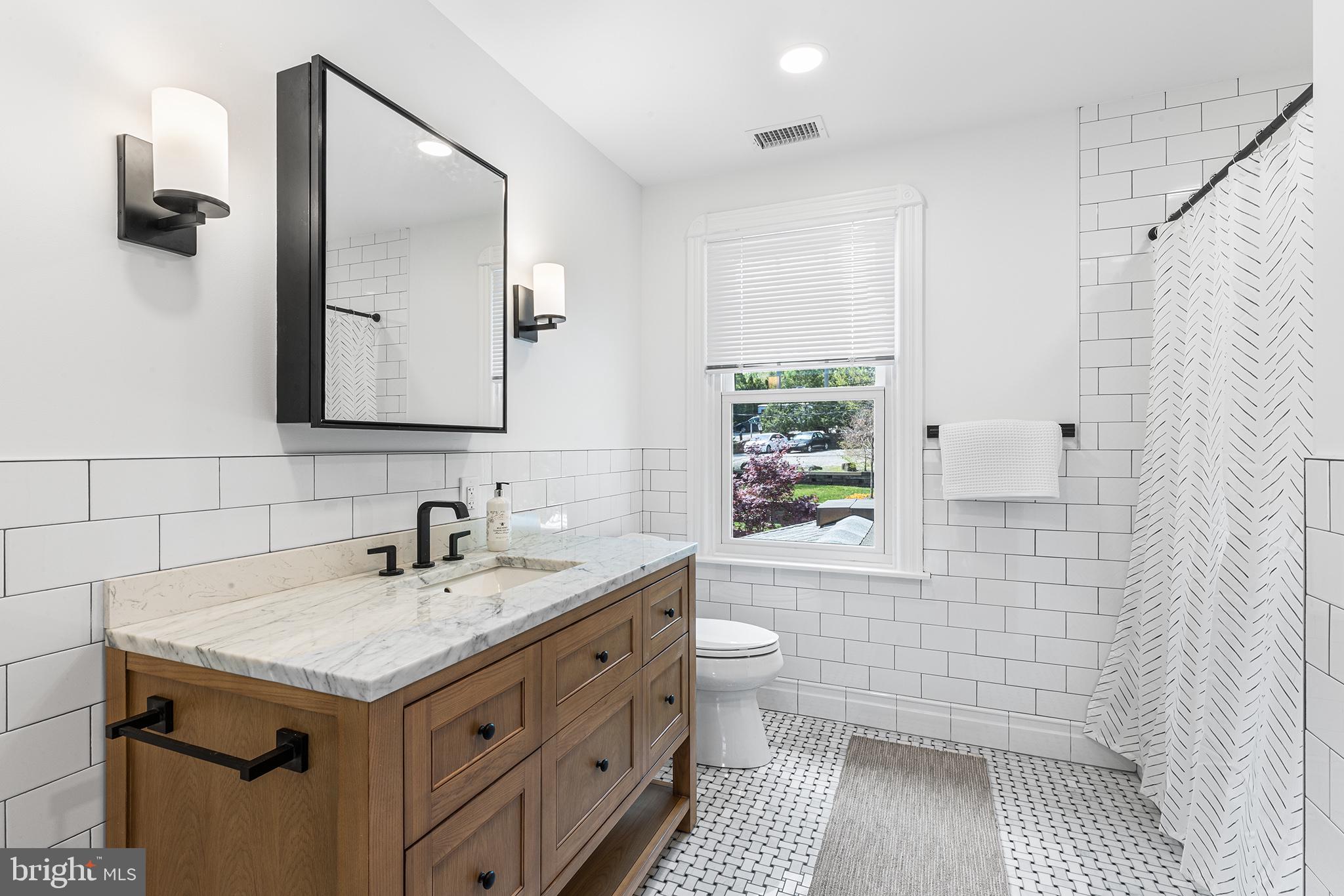 250 Conestoga Road, Unit 2 Wayne, PA 19087 - Photo 14 of 24 a bathroom with a sink a toilet and shower