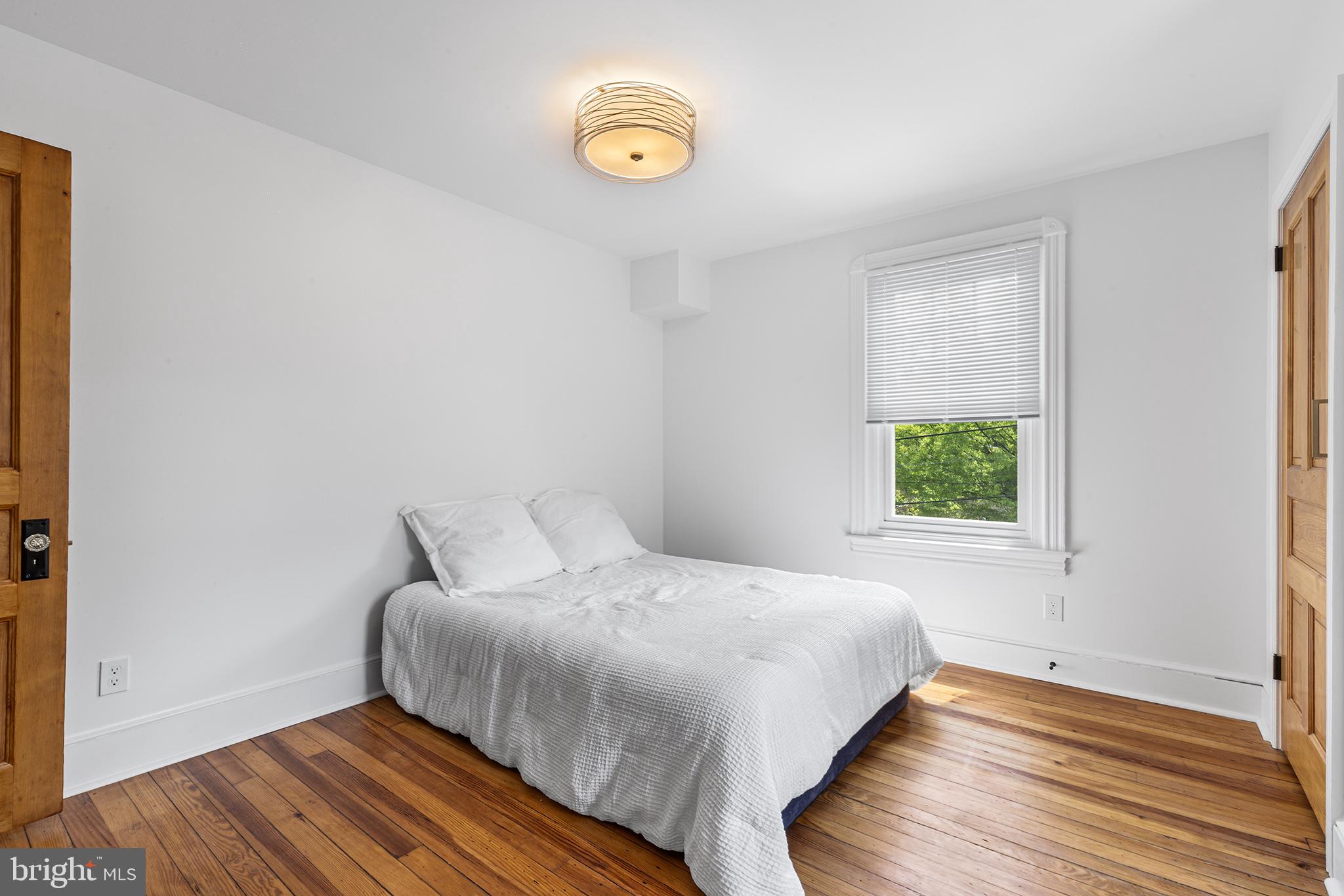 250 Conestoga Road, Unit 2 Wayne, PA 19087 - Photo 17 of 24 a bedroom with a bed and a window