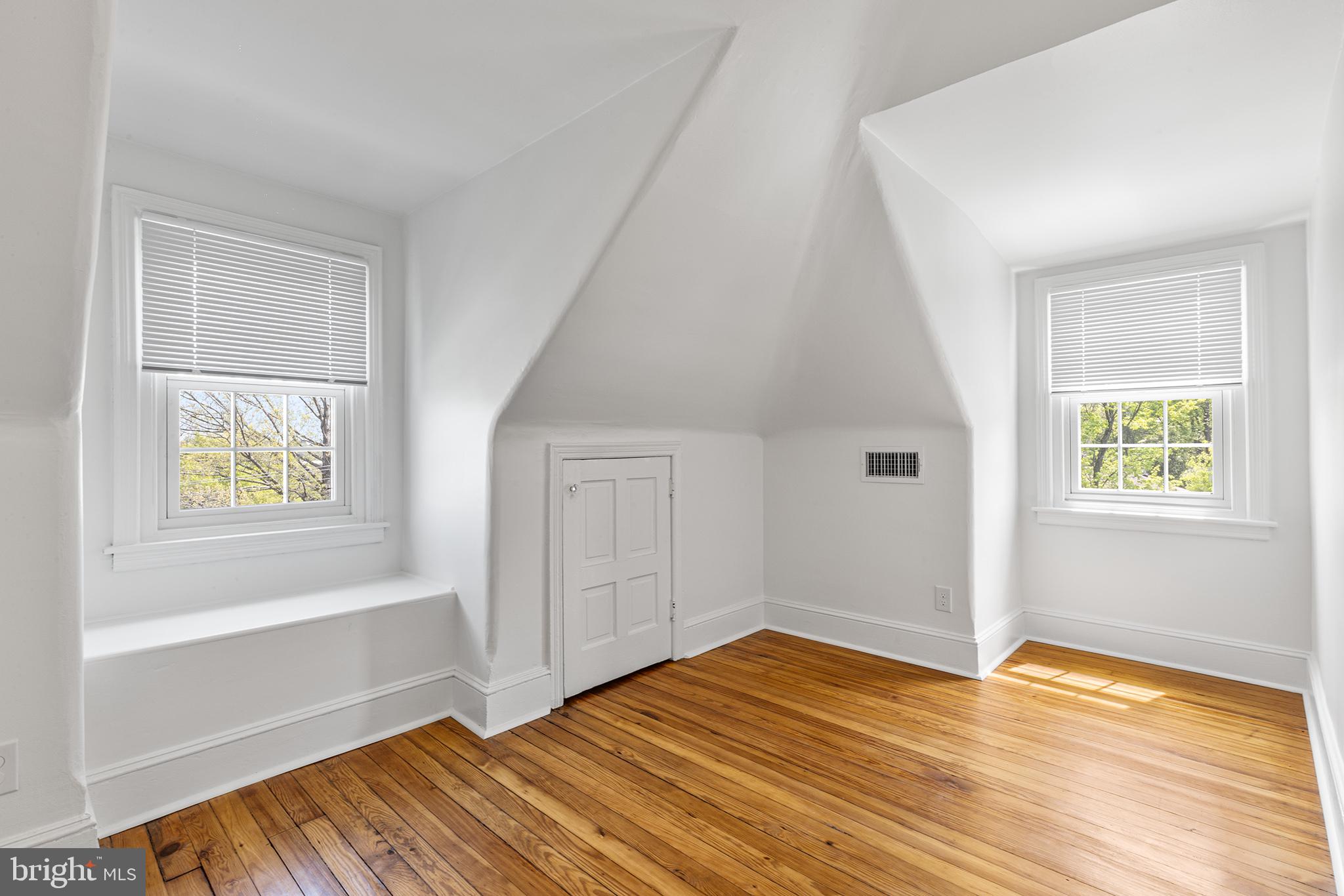 250 Conestoga Road, Unit 2 Wayne, PA 19087 - Photo 21 of 24 a view of an empty room with window and wooden floor