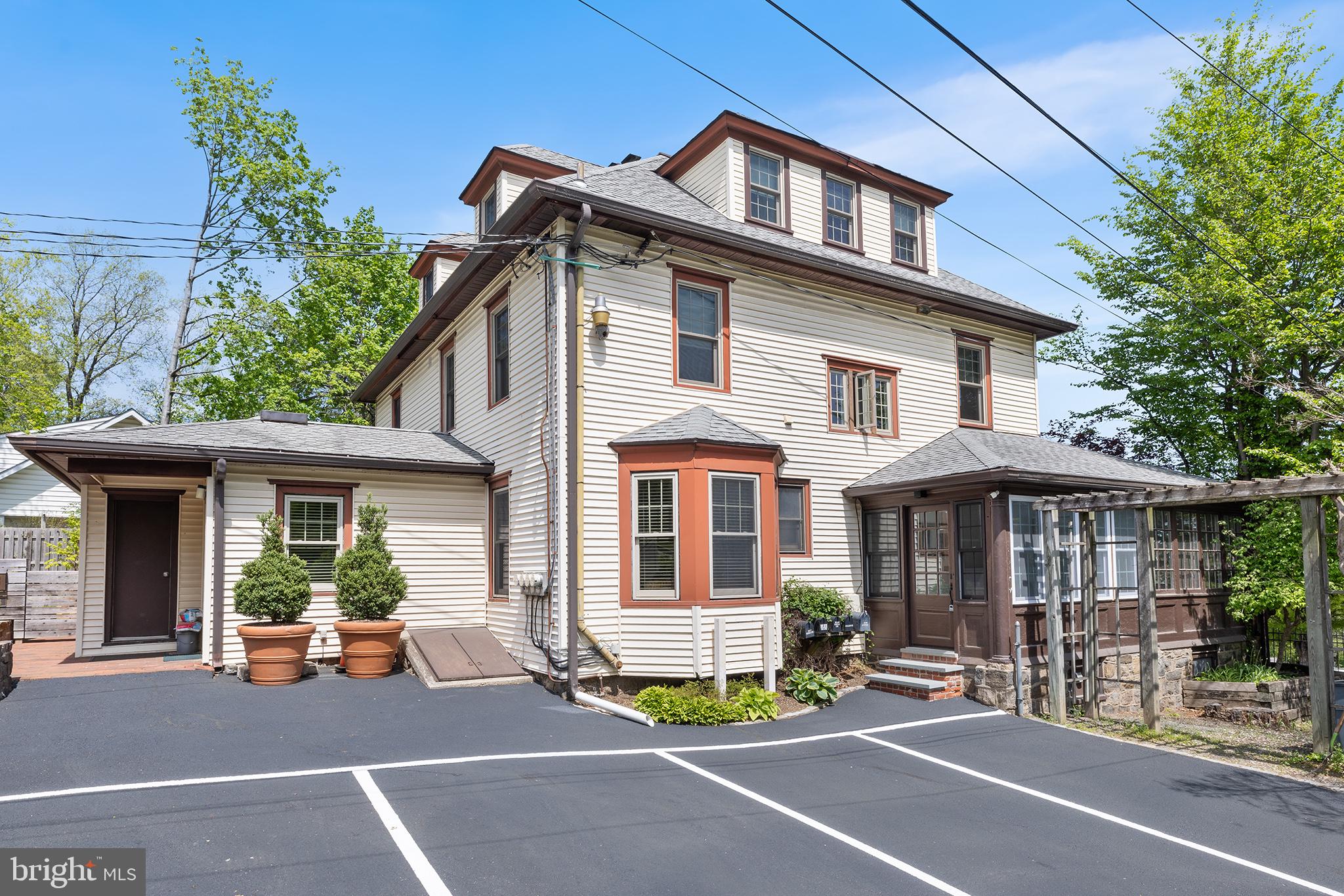 250 Conestoga Road, Unit 2 Wayne, PA 19087 - Photo 23 of 24 a view of a patio with a table and chairs and potted plants
